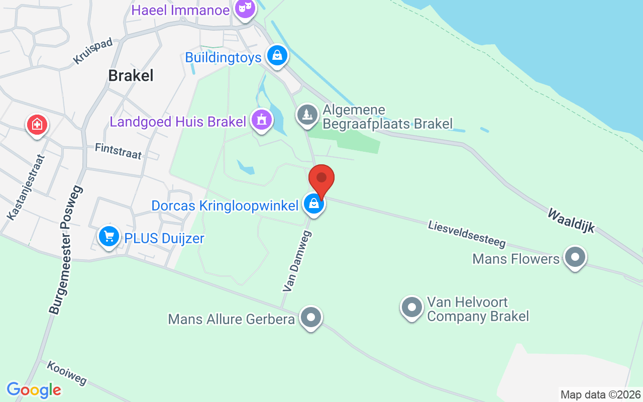 Afbeelding van de ingang van de Dorcas Winkel in Brakel, gelegen aan Van Damme. Een overzicht van de winkel met omliggende groene omgeving en nabijgelegen locaties.