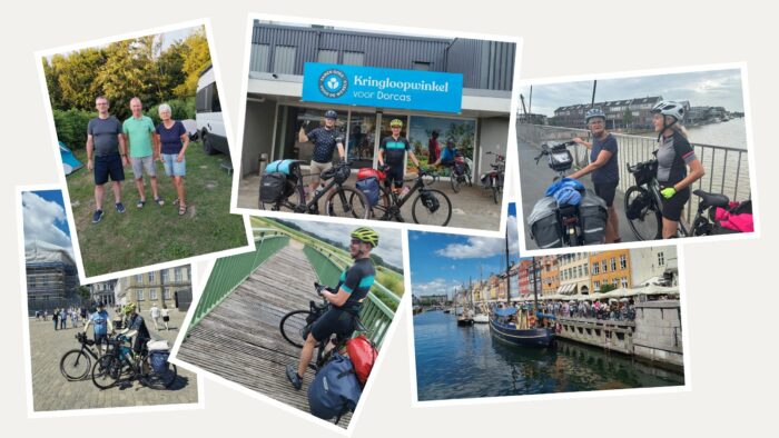 Vijf mensen met fietsen voor een winkel voor Dorcas, actief in humanitaire hulp en noodhulp, in Oost-Europa, Oost-Afrika en het Midden-Oosten.